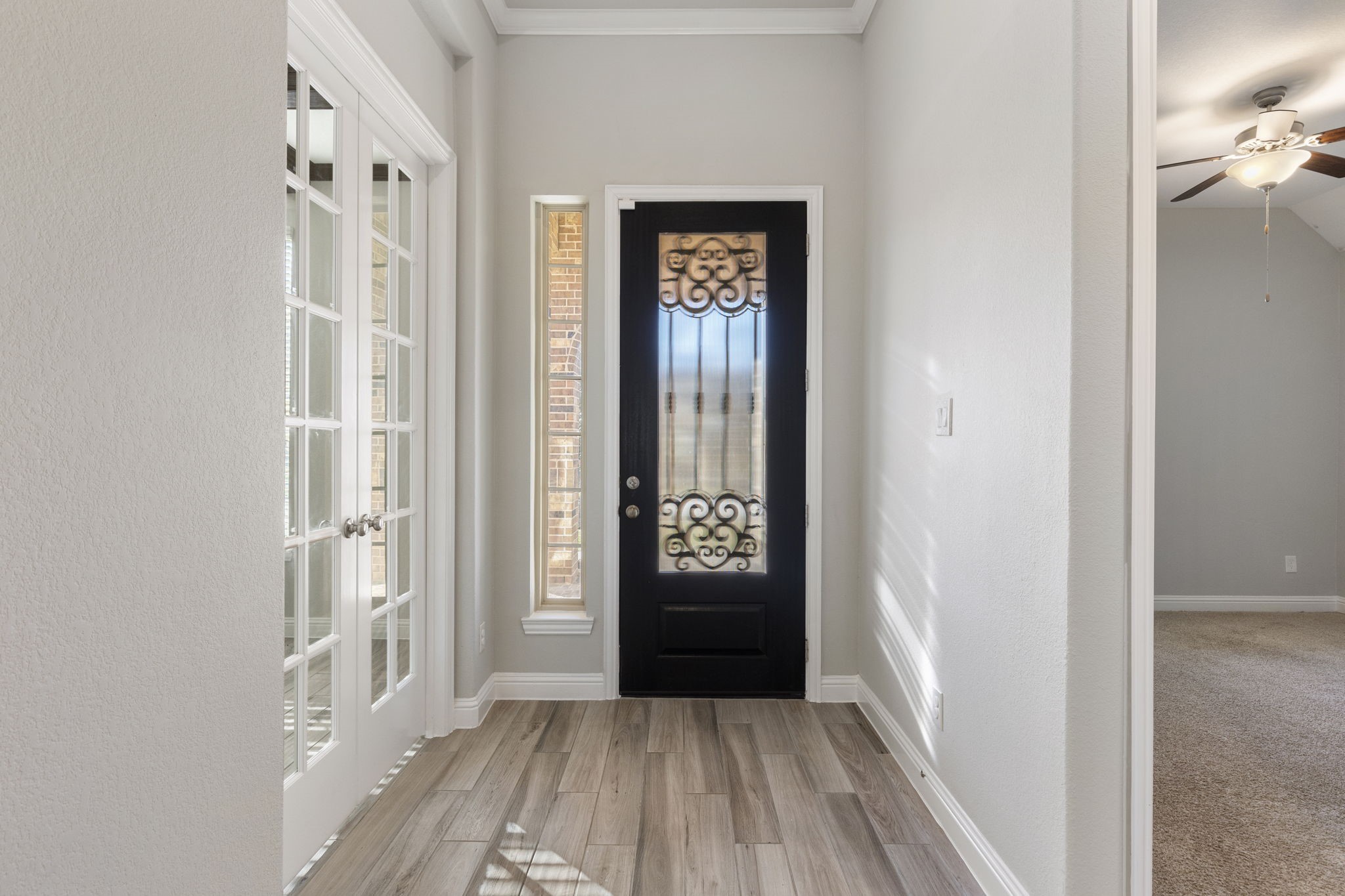 18855 Collins View Drive New Caney, TX 77357 - Photo 6 of 50 a view of a hallway with wooden floor and windows