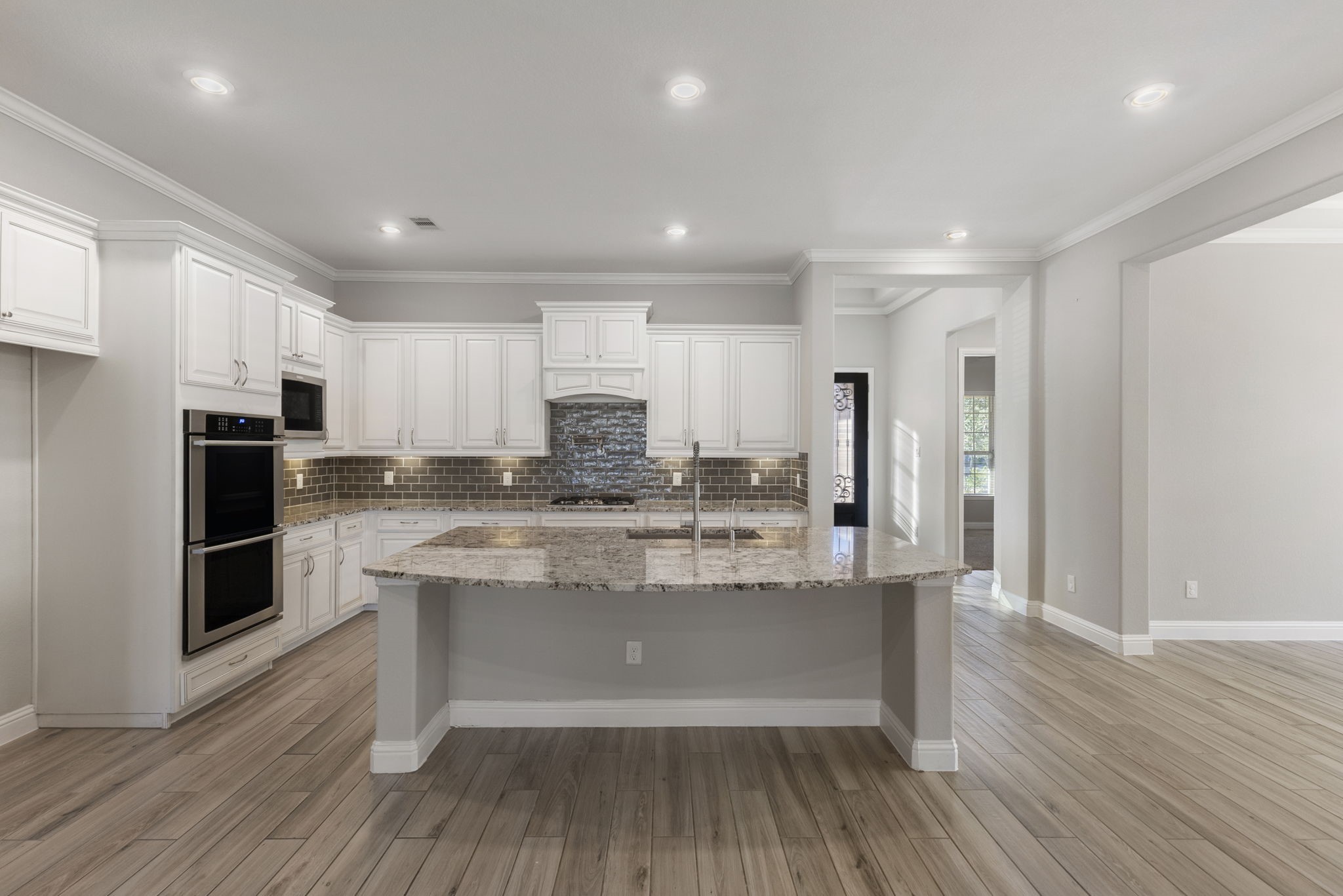 18855 Collins View Drive New Caney, TX 77357 - Photo 8 of 50 a kitchen with kitchen island stainless steel appliances a sink and refrigerator