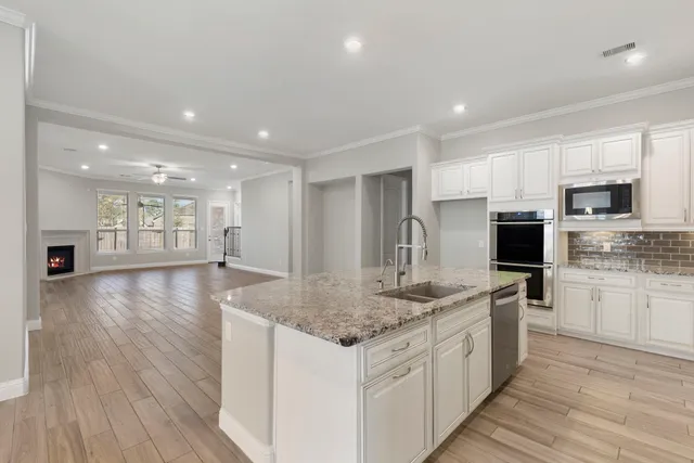 a kitchen with stainless steel appliances granite countertop a sink stove and oven