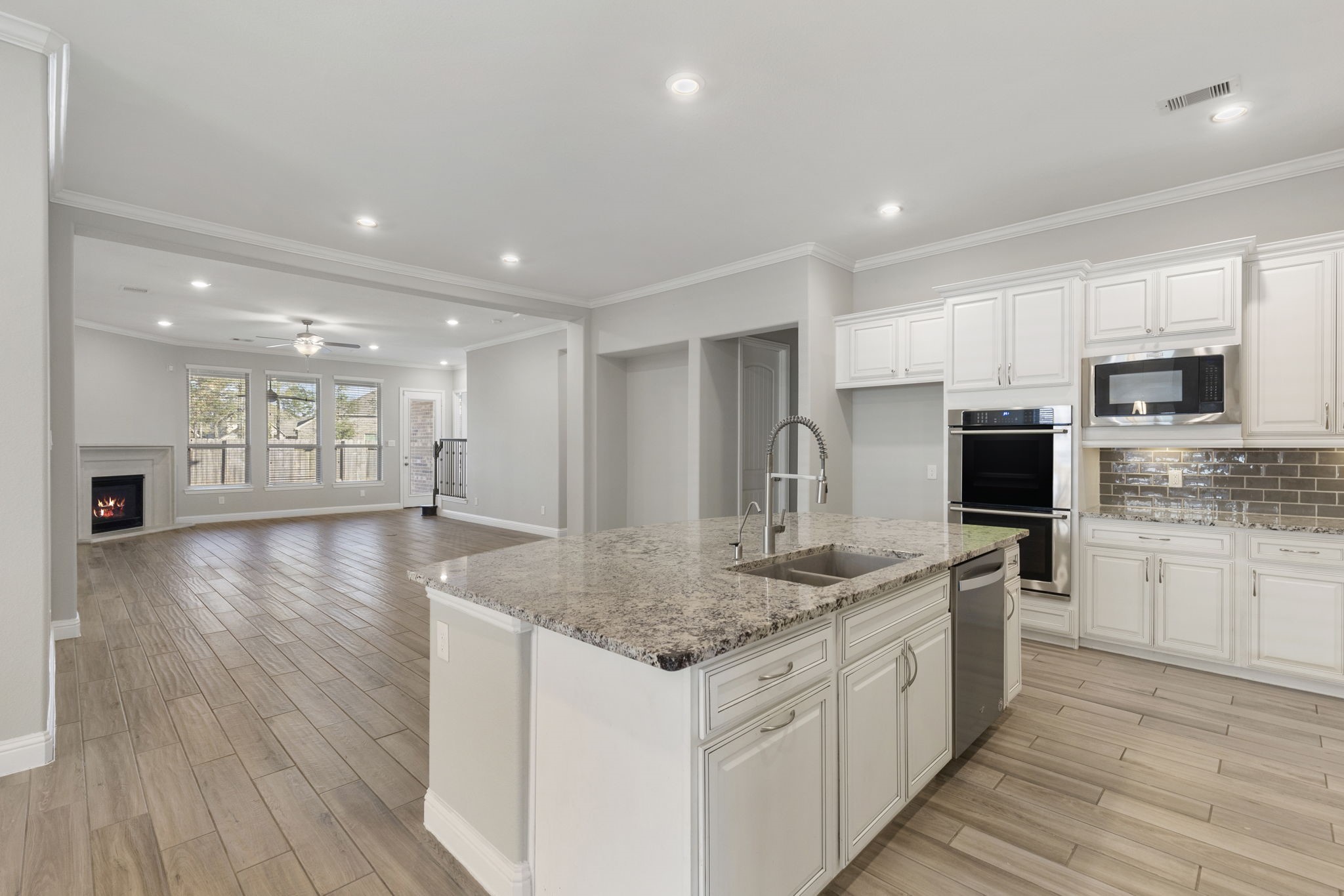 18855 Collins View Drive New Caney, TX 77357 - Photo 9 of 50 a kitchen with stainless steel appliances granite countertop a sink stove and oven