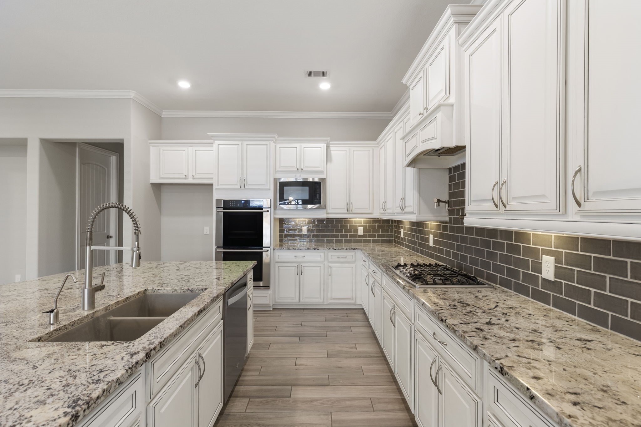 18855 Collins View Drive New Caney, TX 77357 - Photo 10 of 50 a large kitchen with stainless steel appliances granite countertop a sink stove and refrigerator