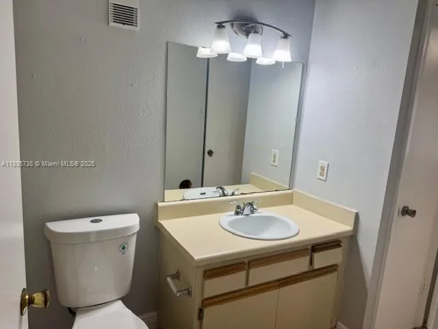 a bathroom with a sink toilet and a mirror