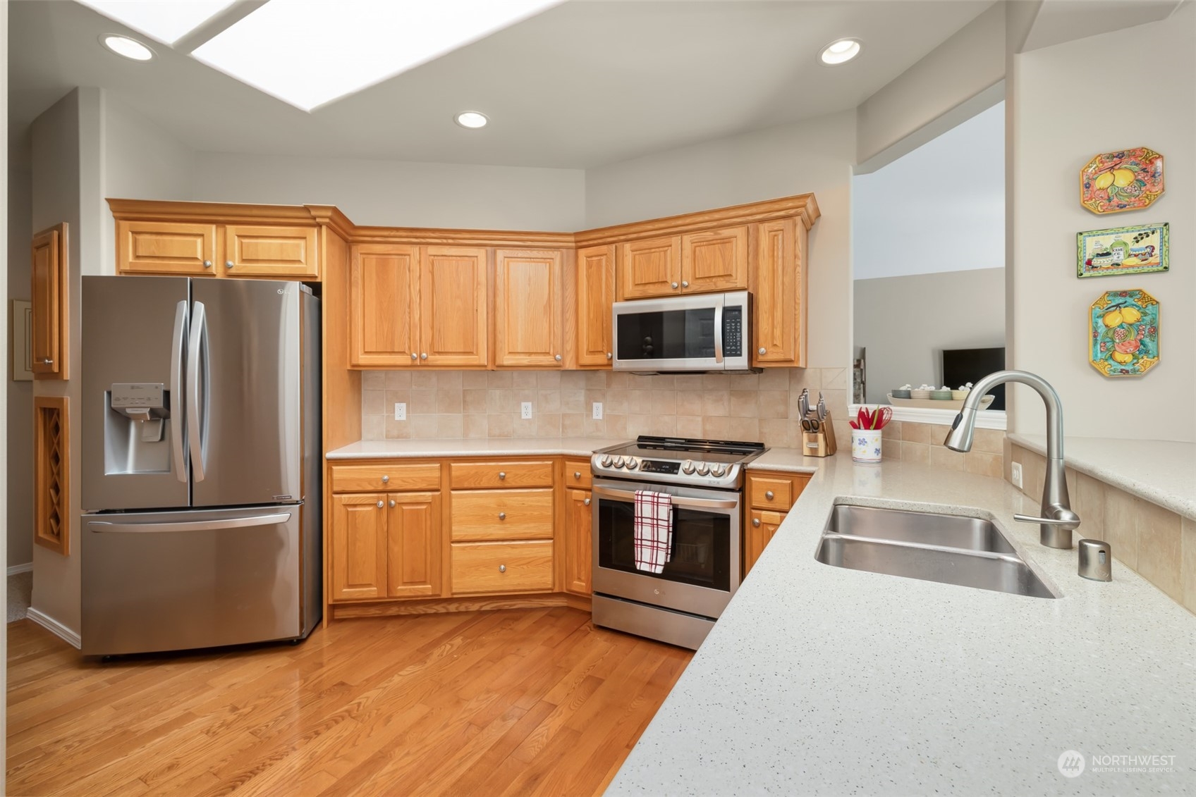 431 Blakely Boulevard Sequim, WA 98382 - Photo 11 of 34 a kitchen with granite countertop a refrigerator stove and microwave