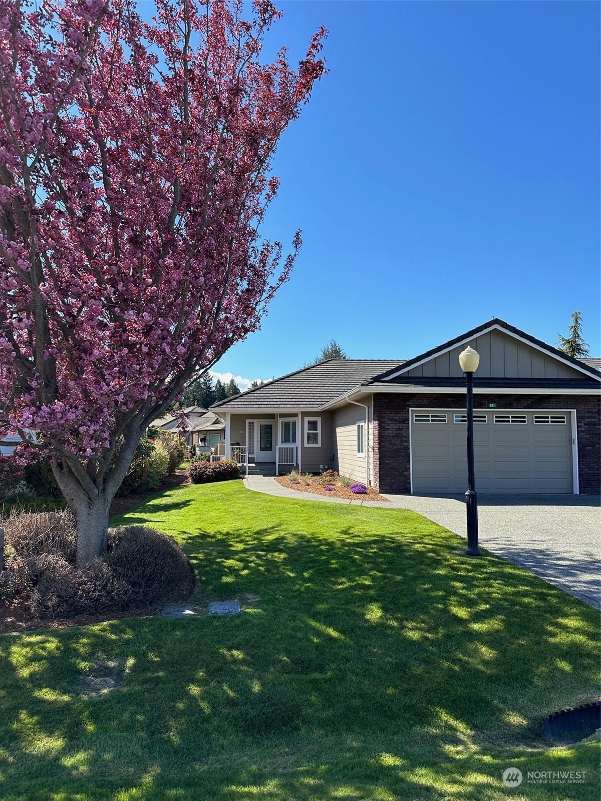 431 Blakely Boulevard Sequim, WA 98382 - Photo 2 of 34 a front view of a house with a yard