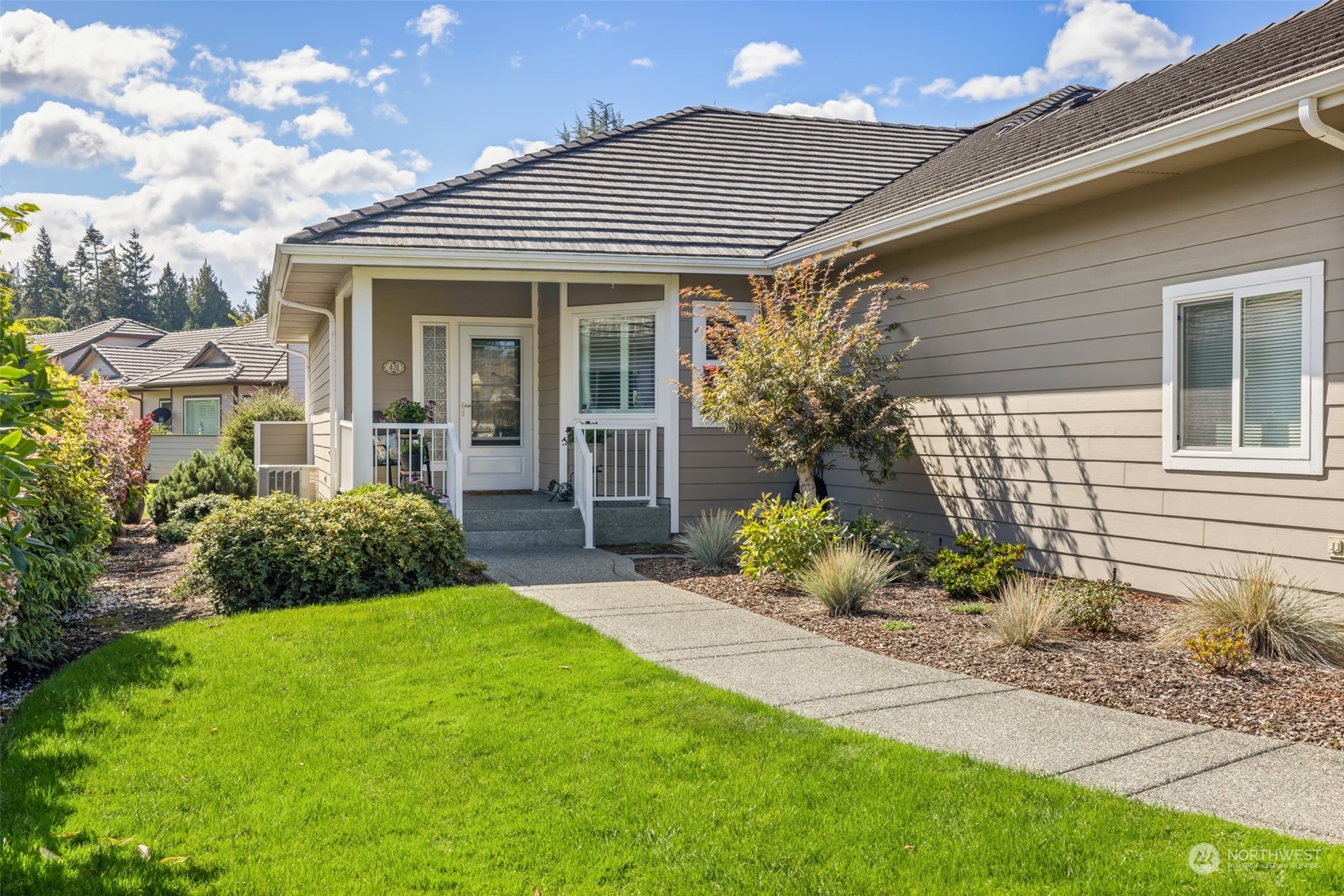 431 Blakely Boulevard Sequim, WA 98382 - Photo 3 of 34 a front view of a house with garden and porch