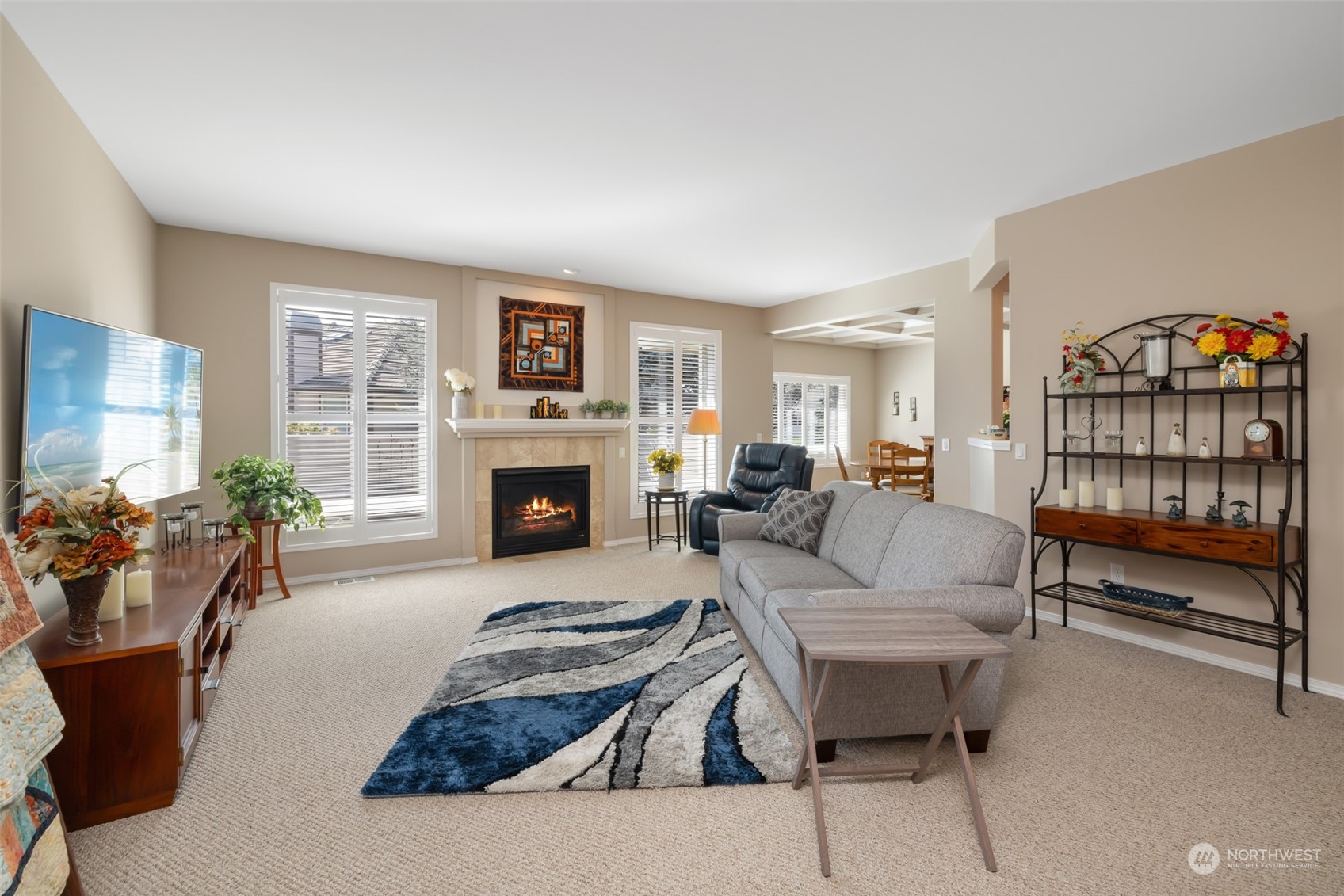 431 Blakely Boulevard Sequim, WA 98382 - Photo 7 of 34 a living room with furniture a fireplace and a flat screen tv