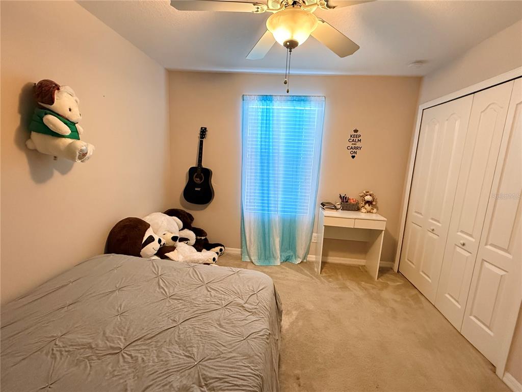 2084 Water Tupelo Way Ocoee, FL 34761 - Photo 19 of 34 a bedroom with a bed and a chandelier