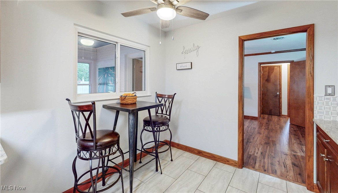 891 Sovereign Road Akron, OH 44303 - Photo 6 of 30 Dining space with ceiling fan and baseboards