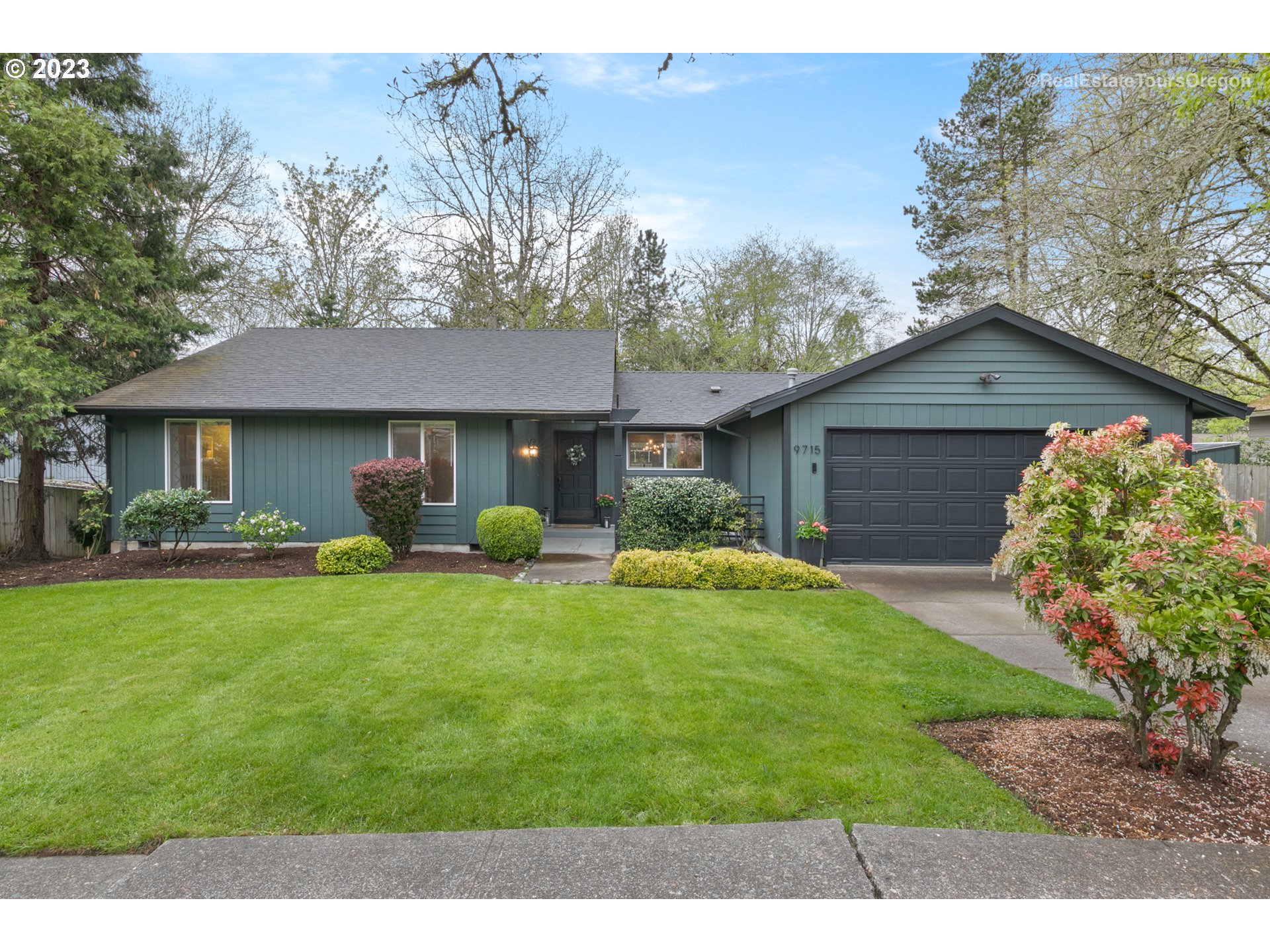 9715 Southwest New Forest Drive Beaverton, OR 97008 - Photo 1 of 32 a front view of a house with a garden