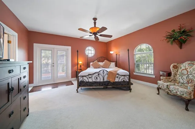 a spacious bedroom with a bed and a chandelier