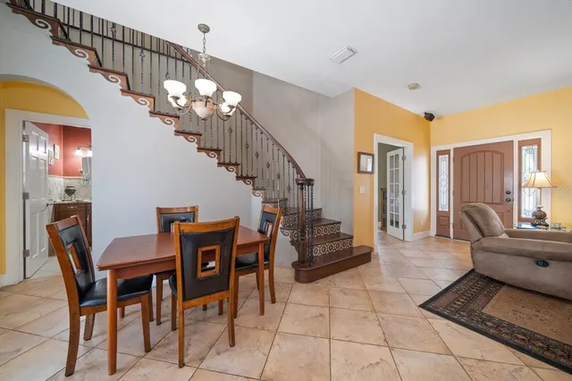 a living room with furniture and a chandelier