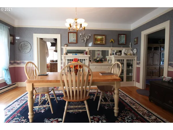 a view of a dining room with furniture and chandelier