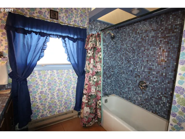 a bathroom with a bathtub and shower