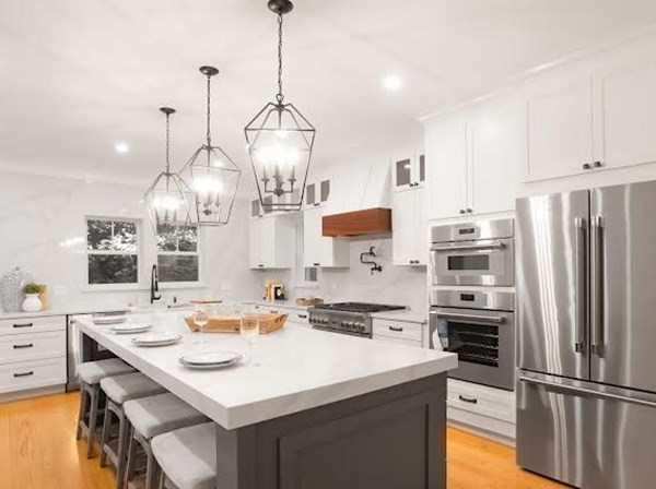 90 Evergreen Road Natick, MA 01760 - Photo 18 of 22 a kitchen with stainless steel appliances kitchen island granite countertop a sink a stove a refrigerator and island with wooden floor