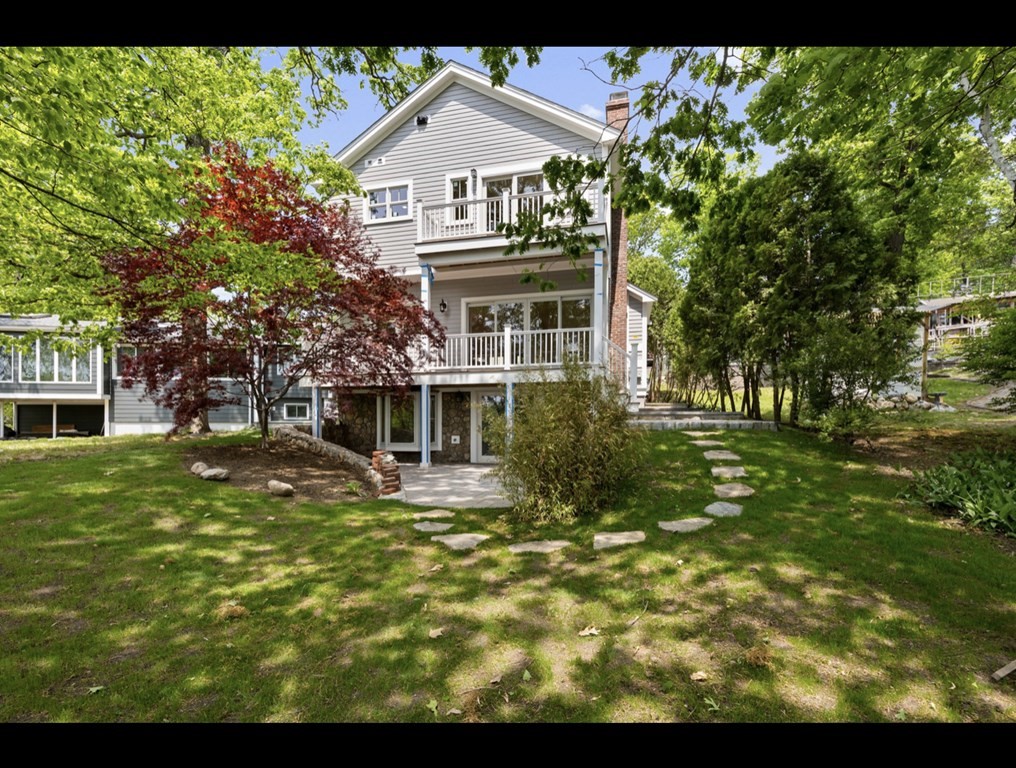 90 Evergreen Road Natick, MA 01760 - Photo 7 of 22 a front view of a house with a garden
