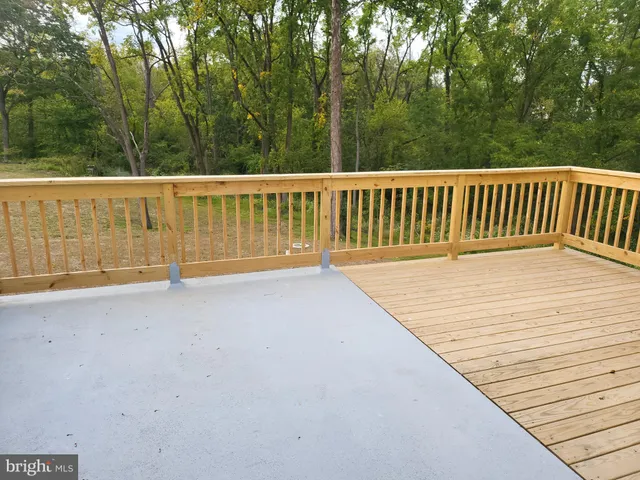 a view of a field with trees in the background