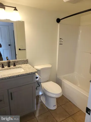 a view of a field with trees in the background