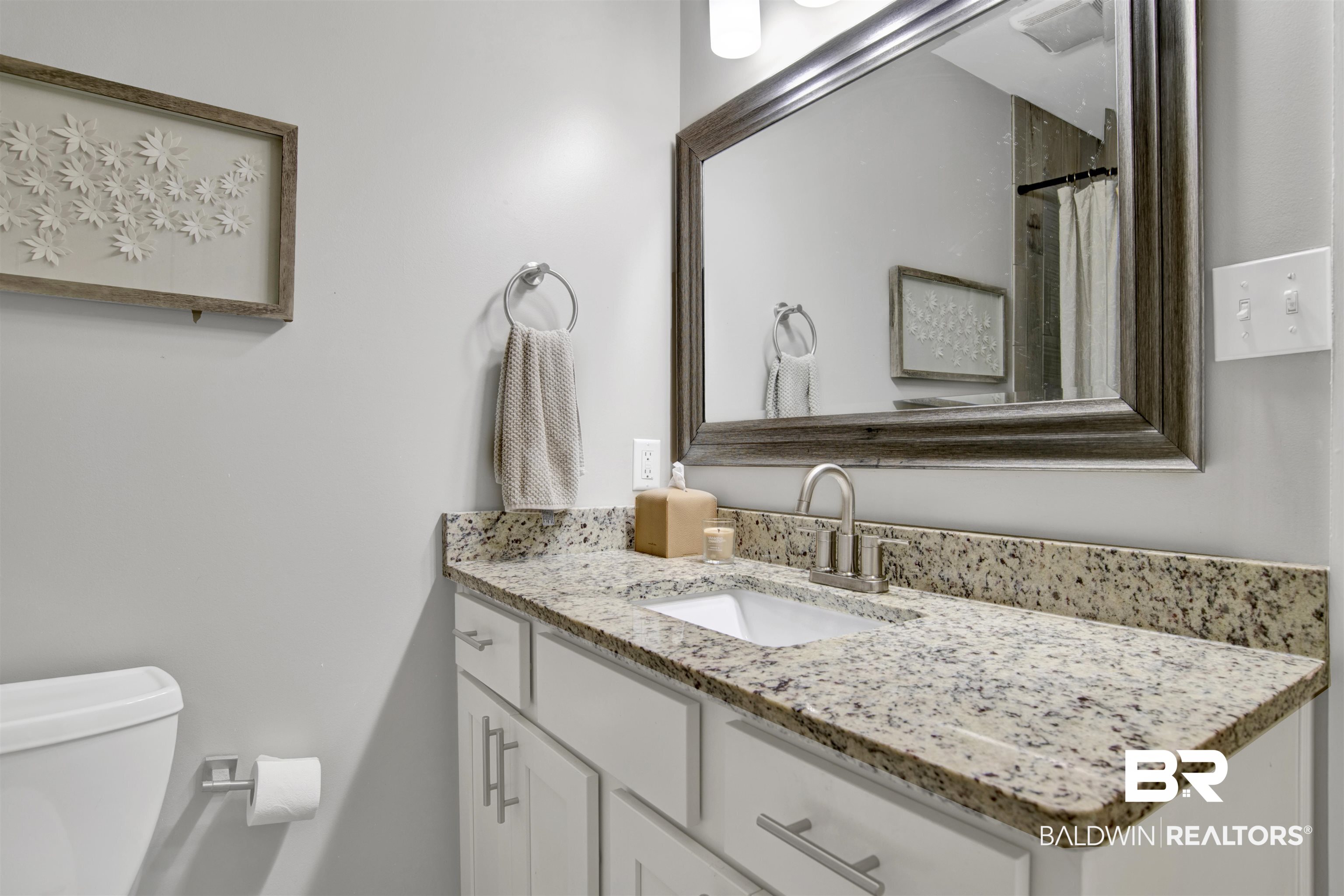 253 Maplewood Loop Daphne, AL 36526 - Photo 24 of 30 Modern bathroom vanity featuring a granite countertop with an undermount sink, brushed nickel faucet, and white cabinetry with coordinating hardware