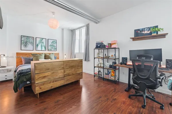 a bedroom with furniture and a wooden floor
