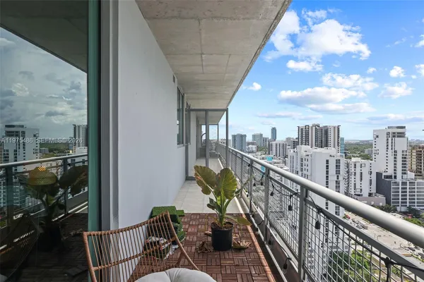 a view of a balcony with furniture