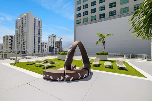 a view of a swimming pool with a yard and seating