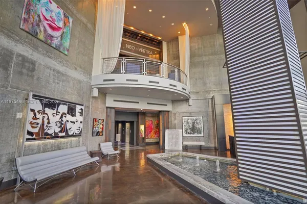 a view of a building with door and outdoor seating