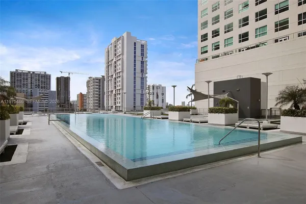 a view of swimming pool with outdoor seating and plants