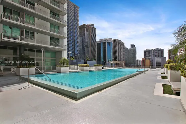 a view of a building with a garden and sitting area