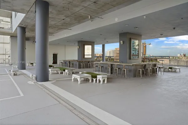 a view of a dining room with furniture chandelier and a large window