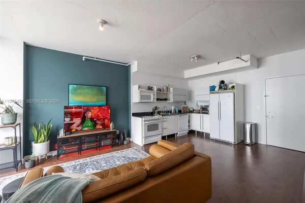 a living room with furniture and a flat screen tv