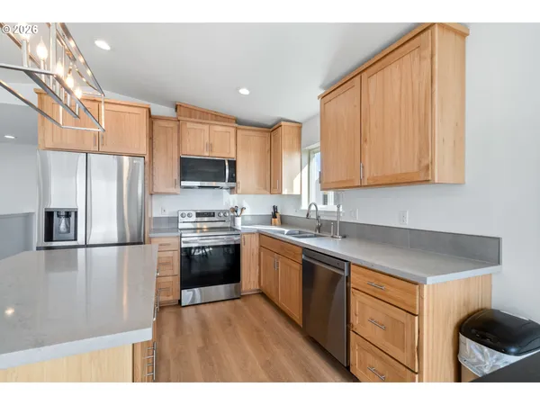 a kitchen with stainless steel appliances granite countertop a refrigerator sink and cabinets