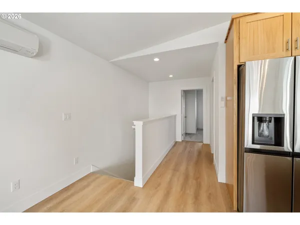 a view of a hallway with a refrigerator