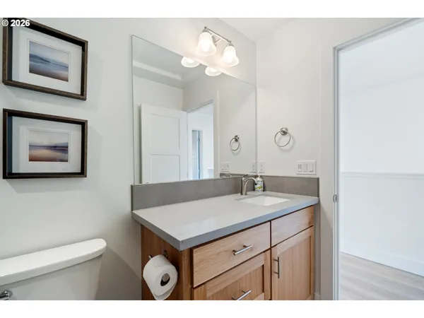 a bathroom with a sink a vanity and a toilet