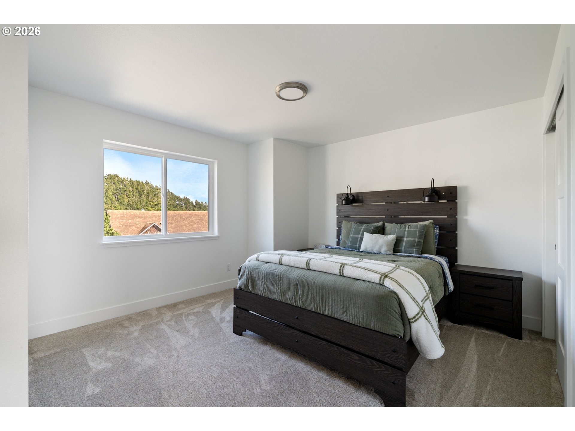 120 Reeder Street Tillamook, OR 97141 - Photo 24 of 41 a bedroom with a bed and a window