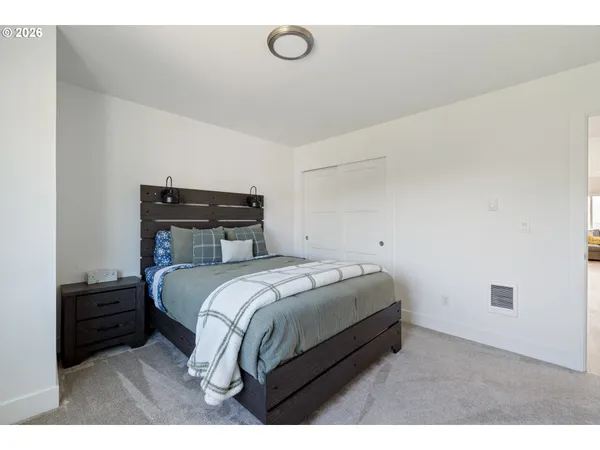 a bedroom with a bed and a night stand