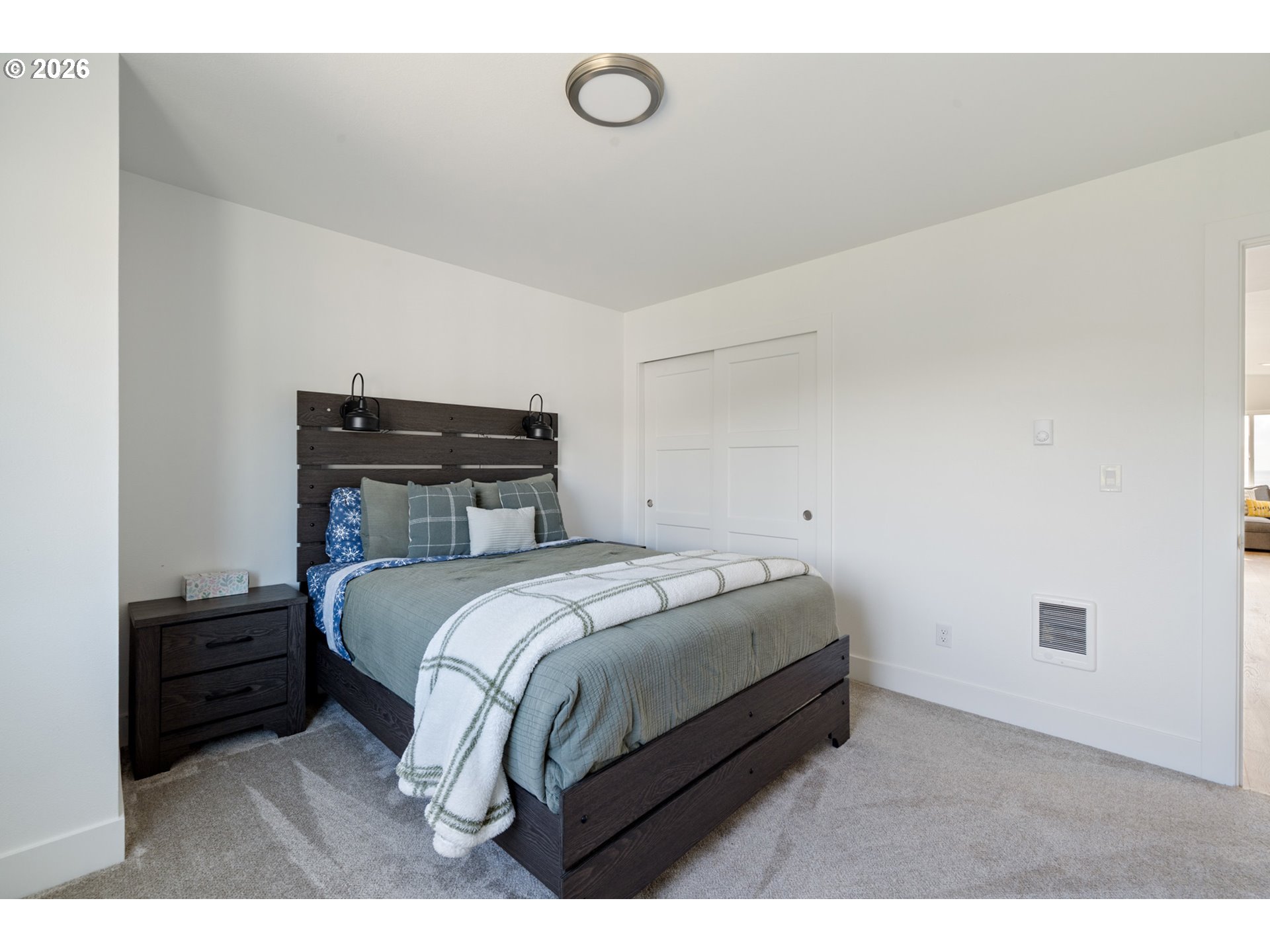 120 Reeder Street Tillamook, OR 97141 - Photo 25 of 41 a bedroom with a bed and a night stand