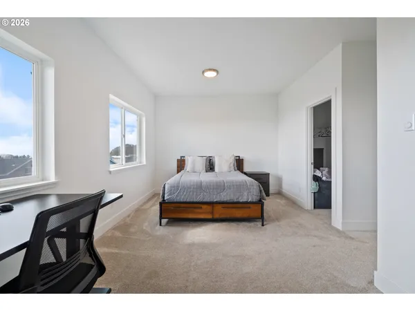 a bedroom with bed and a window