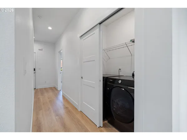 a view of a hallway with wooden floor