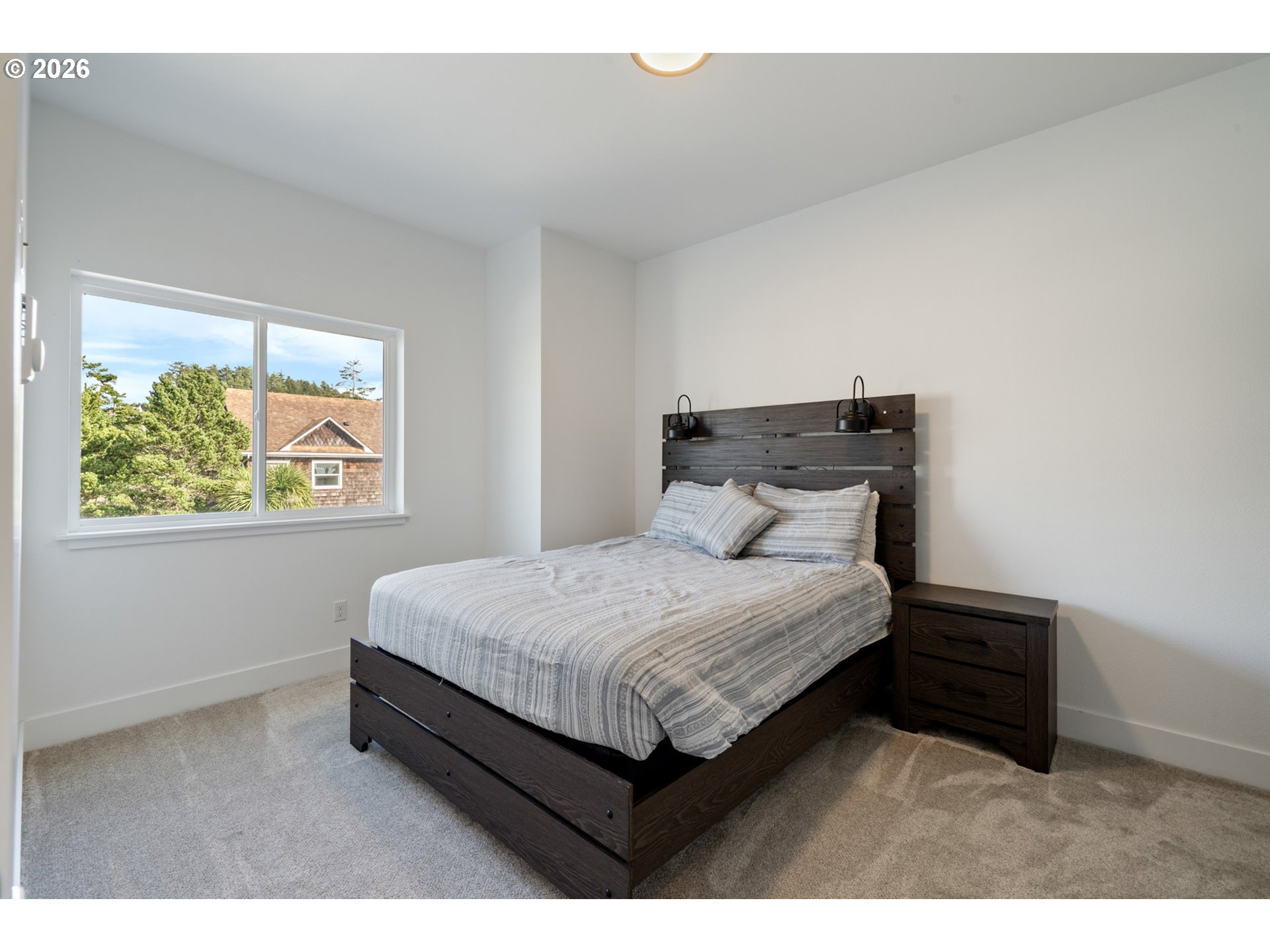 120 Reeder Street Tillamook, OR 97141 - Photo 32 of 41 a bed sitting in a bedroom next to a window