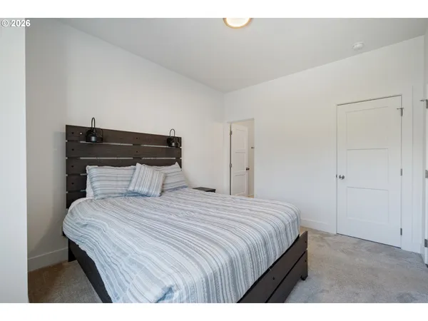 a bedroom with a bed and a night stand