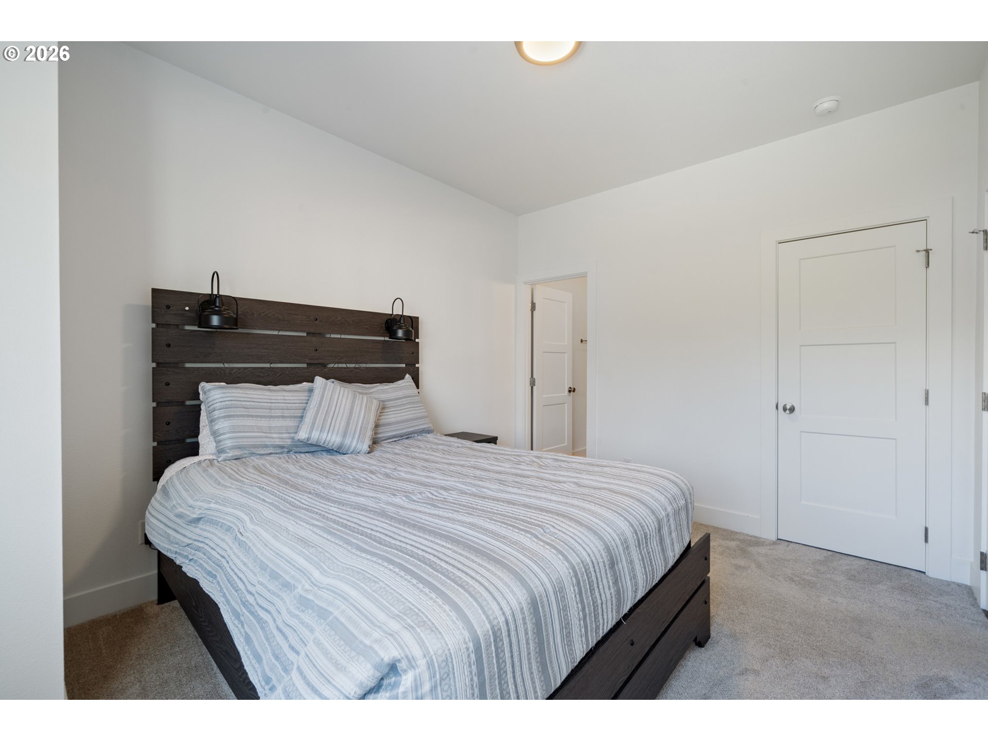 120 Reeder Street Tillamook, OR 97141 - Photo 33 of 41 a bedroom with a bed and a night stand