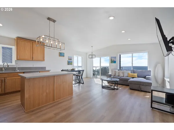 a living room with granite countertop furniture a couch and chandelier