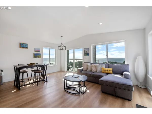 a living room with furniture wooden floor and a window