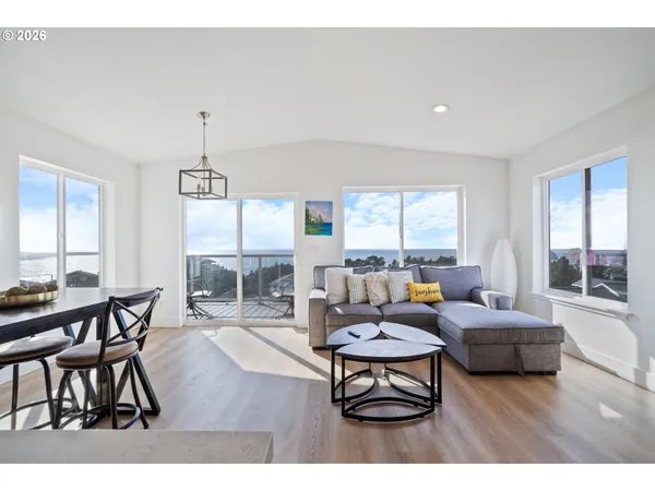 a living room with fireplace furniture and a large window