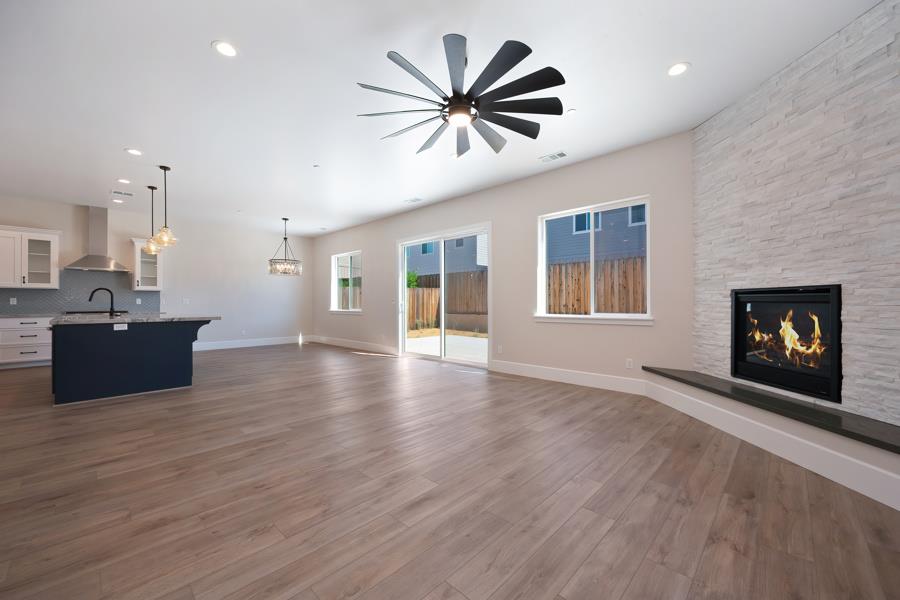 3301 Stone Field Way Loomis, CA 95650 - Photo 12 of 33 an open kitchen with a sink and a fireplace