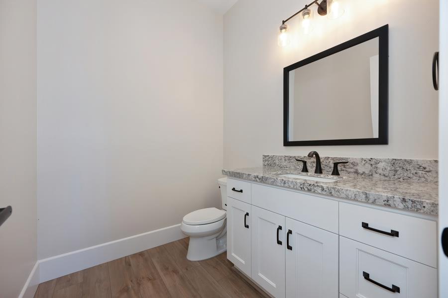 3301 Stone Field Way Loomis, CA 95650 - Photo 14 of 33 a bathroom with a granite countertop toilet sink and mirror