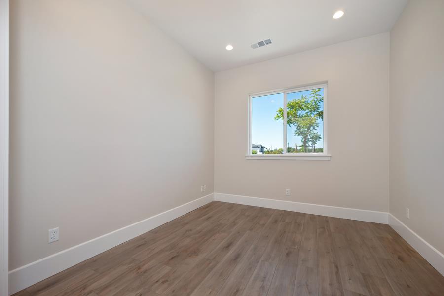 3301 Stone Field Way Loomis, CA 95650 - Photo 15 of 33 a view of an empty room with wooden floor and a window