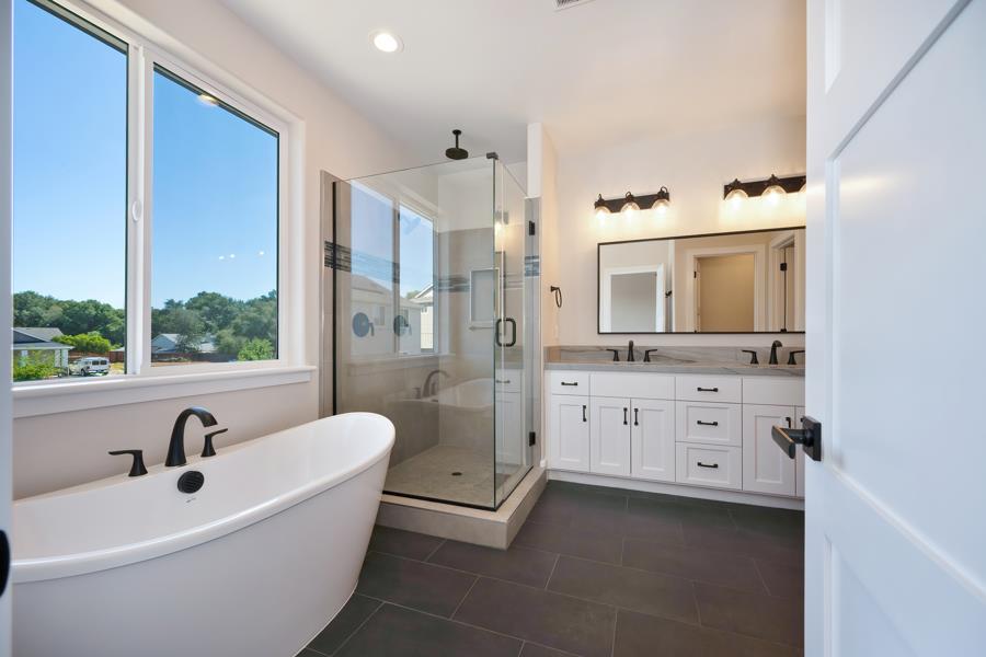3301 Stone Field Way Loomis, CA 95650 - Photo 20 of 33 a spacious bathroom with a double vanity sink a mirror a bathtub and shower