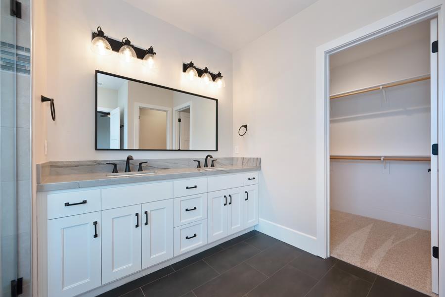 3301 Stone Field Way Loomis, CA 95650 - Photo 21 of 33 a bathroom with a double vanity sink and a mirror
