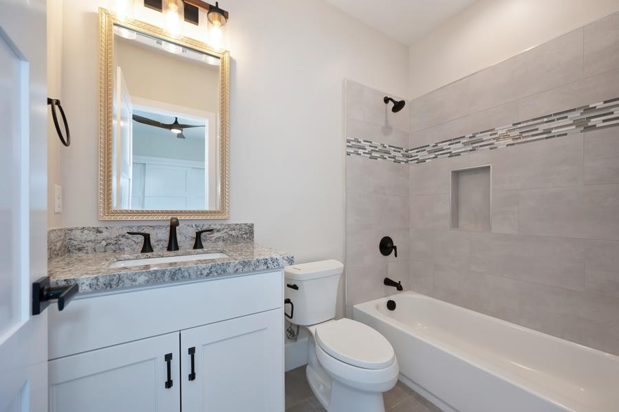 3301 Stone Field Way Loomis, CA 95650 - Photo 27 of 33 a bathroom with a granite countertop sink toilet and shower